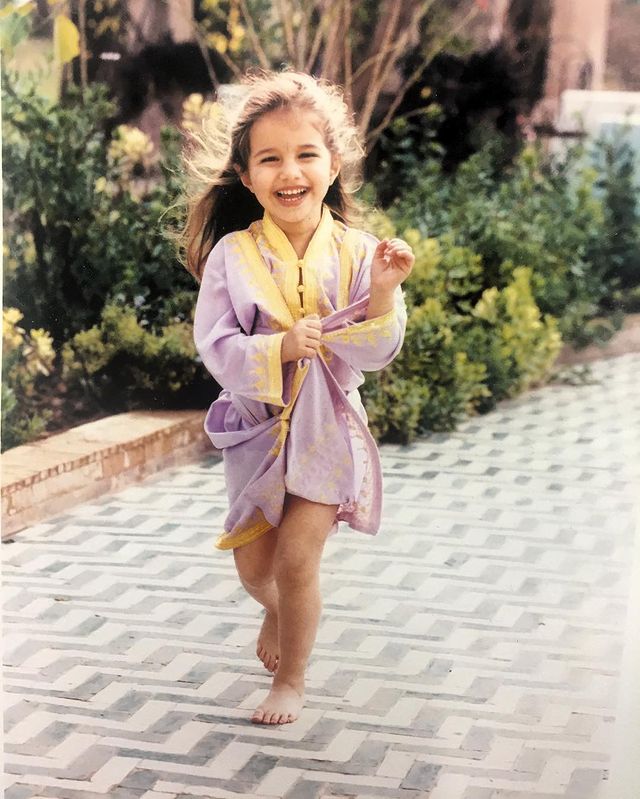 Childhood photo of Shana Leelee Chasman in a yellow and violet color dress.